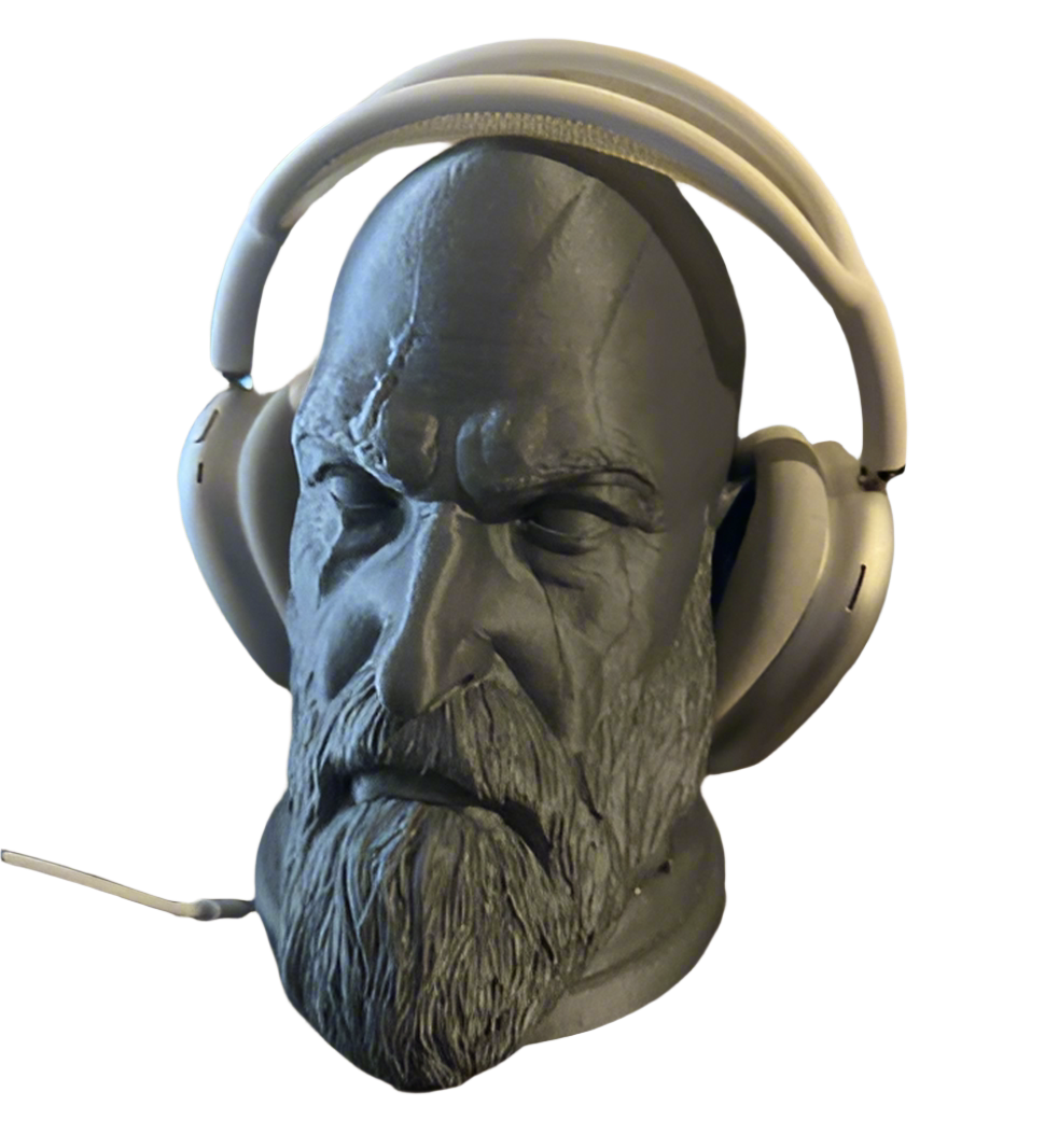 Gray stone sculpture of a face wearing white headphones 